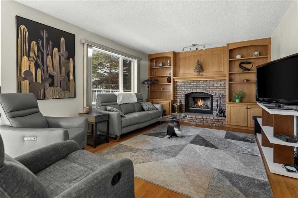 332 Hawkstone Close Nw, Calgary, AB - Indoor Photo Showing Living Room With Fireplace