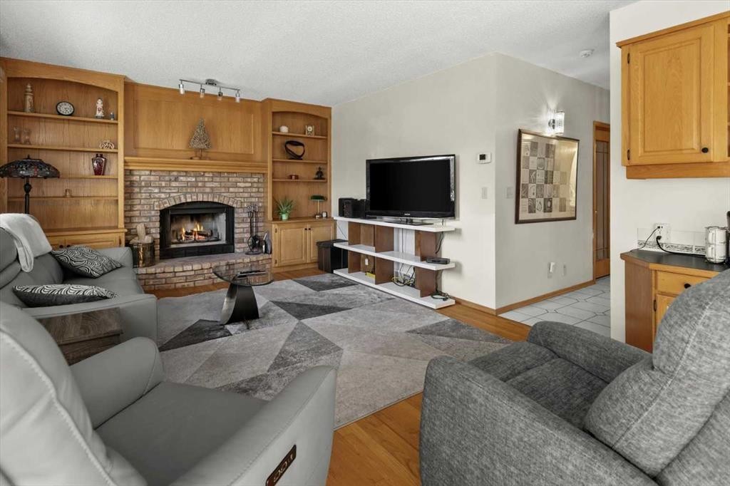 332 Hawkstone Close Nw, Calgary, AB - Indoor Photo Showing Living Room With Fireplace