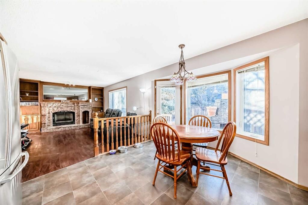 78 Sandringham Way Nw, Calgary, AB - Indoor Photo Showing Dining Room With Fireplace