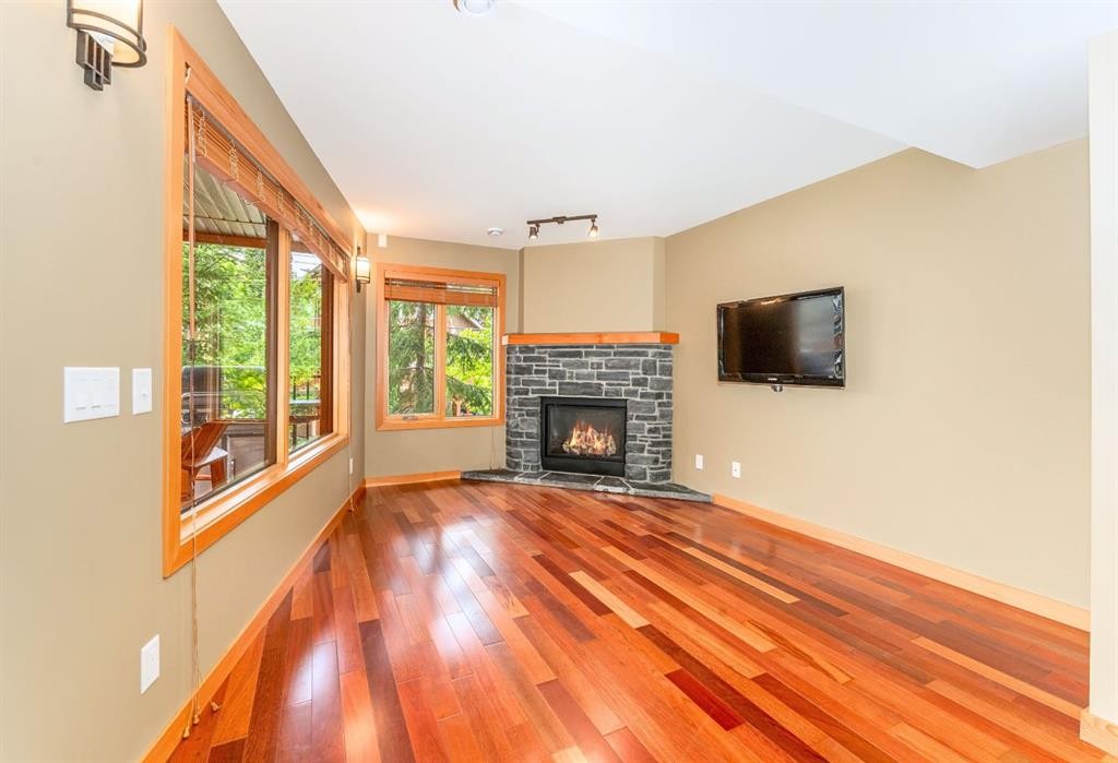 2-722 3Rd Street, Canmore, AB - Indoor Photo Showing Living Room With Fireplace