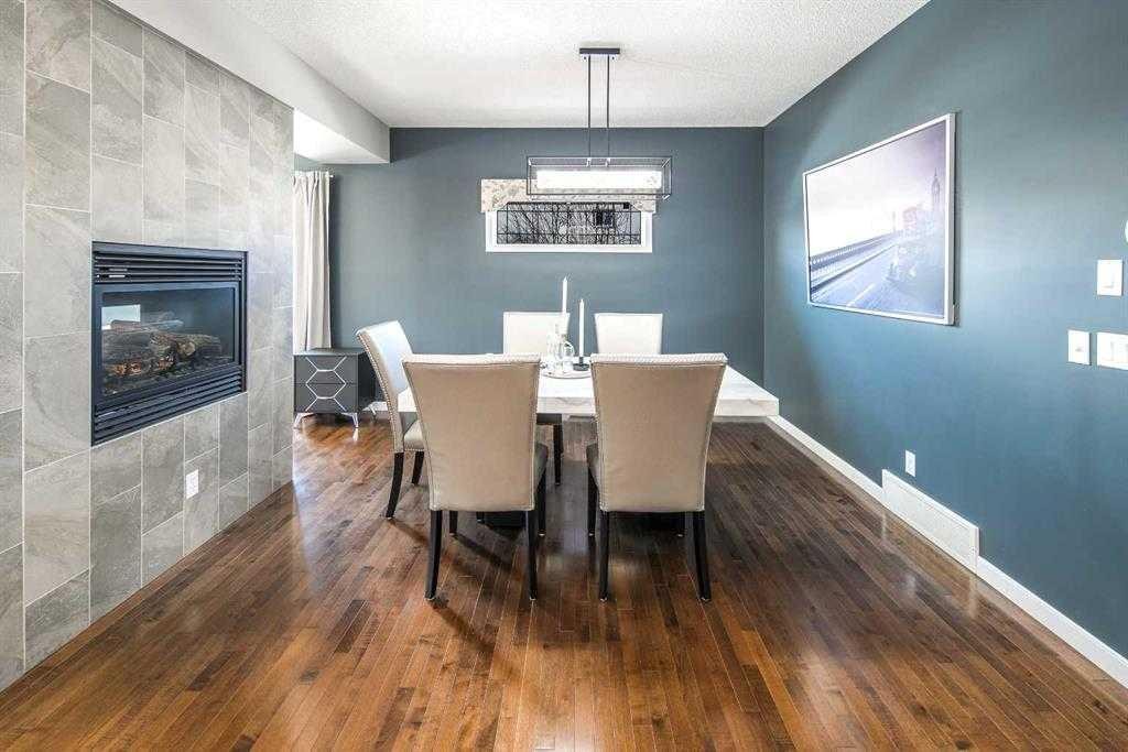 5 Panatella Square Nw, Calgary, AB - Indoor Photo Showing Dining Room With Fireplace