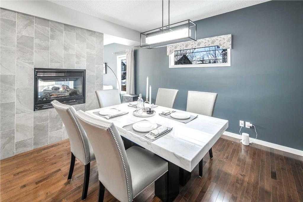 5 Panatella Square Nw, Calgary, AB - Indoor Photo Showing Dining Room With Fireplace