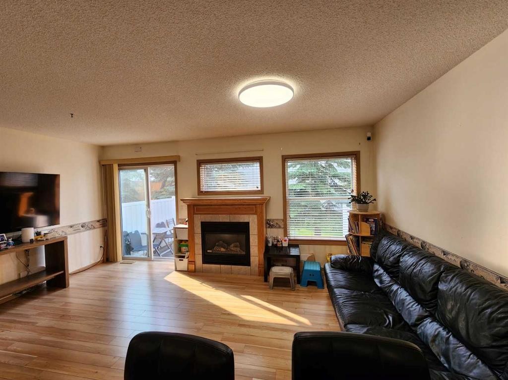 9 Country Hills Rise Nw, Calgary, AB - Indoor Photo Showing Living Room With Fireplace