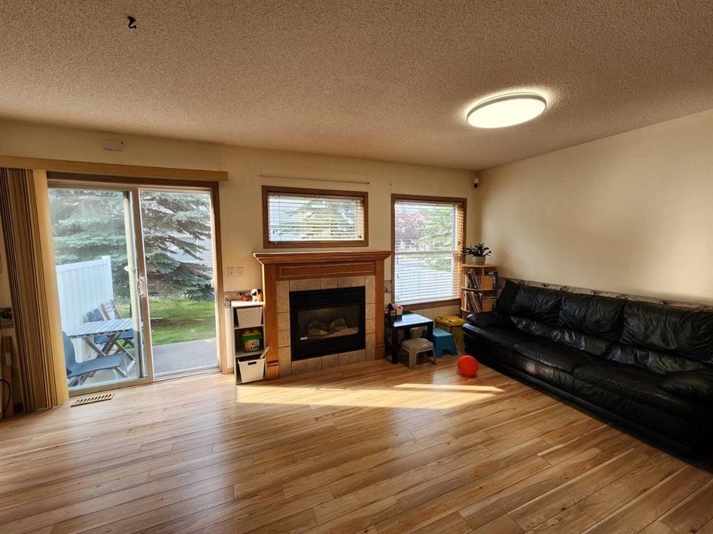 9 Country Hills Rise Nw, Calgary, AB - Indoor Photo Showing Living Room With Fireplace