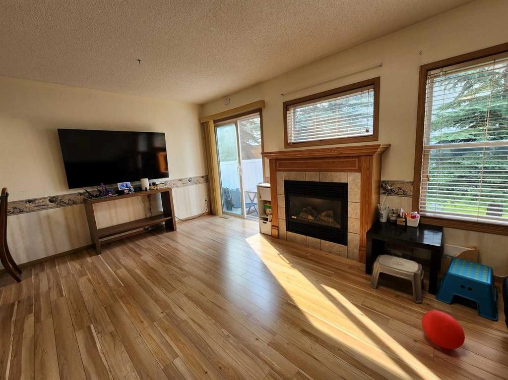 9 Country Hills Rise Nw, Calgary, AB - Indoor Photo Showing Living Room With Fireplace
