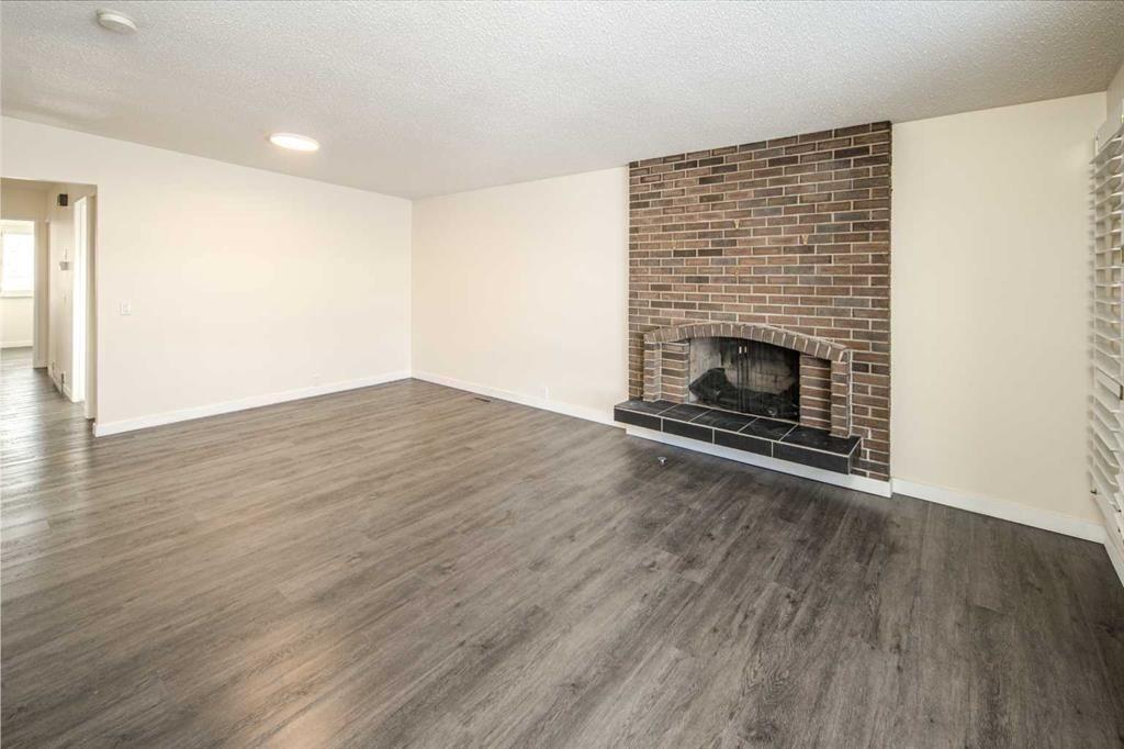 4712 Vegas Road Nw, Calgary, AB - Indoor Photo Showing Living Room With Fireplace