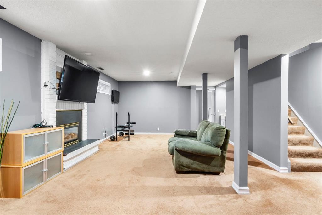 16 Woodacres Drive Sw, Calgary, AB - Indoor Photo Showing Other Room With Fireplace