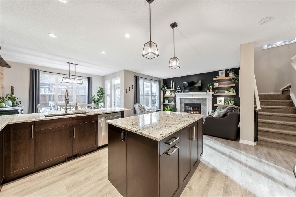 159 Riviera View, Cochrane, AB - Indoor Photo Showing Kitchen With Fireplace With Double Sink