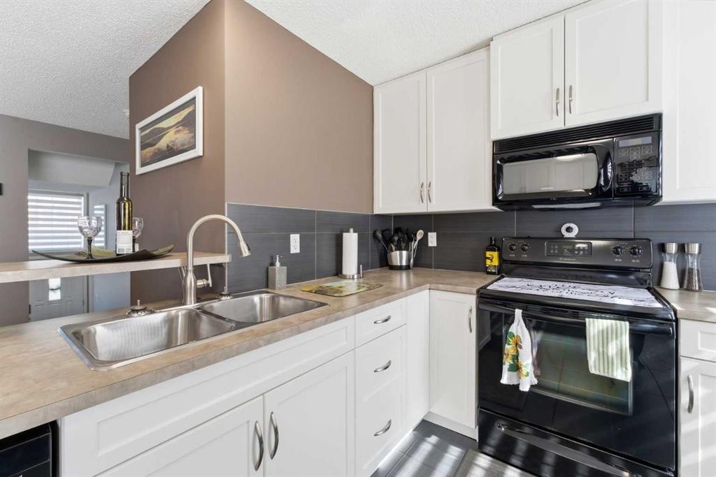 59 New Brighton Common Se, Calgary, AB - Indoor Photo Showing Kitchen With Double Sink