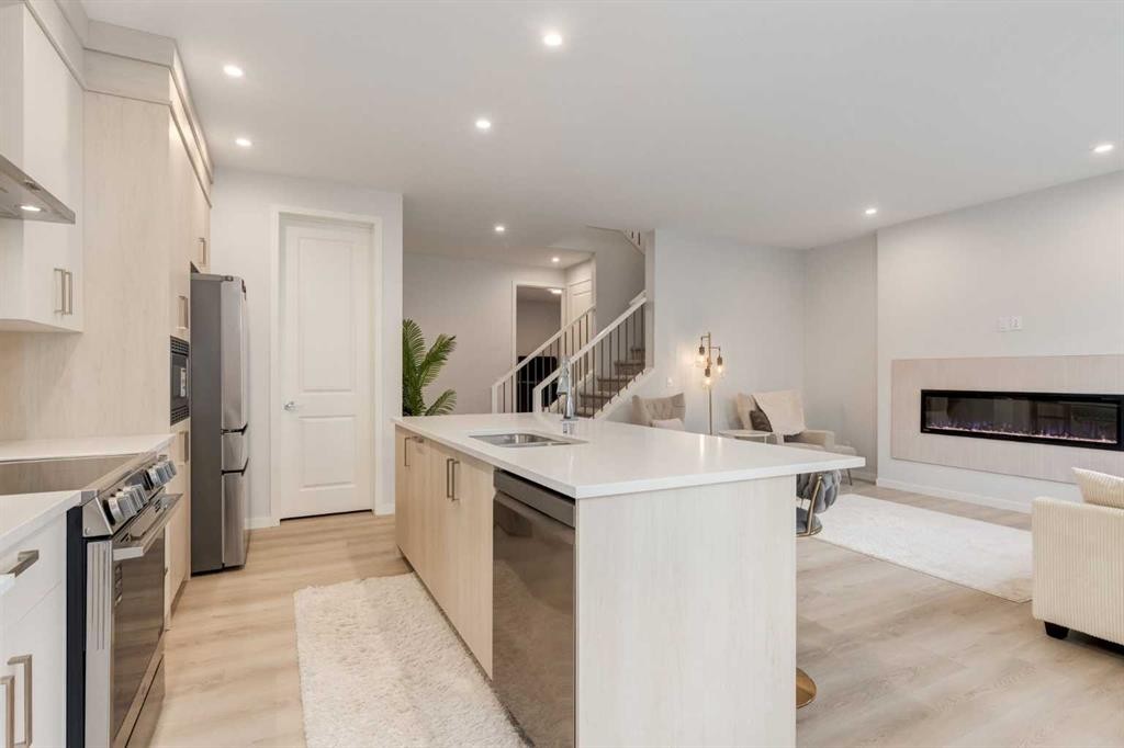 29 Marmot Passage Nw, Calgary, AB - Indoor Photo Showing Kitchen With Fireplace