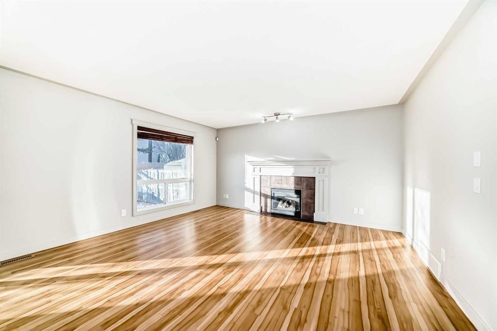 1156 Sherwood Boulevard Nw, Calgary, AB - Indoor Photo Showing Living Room With Fireplace