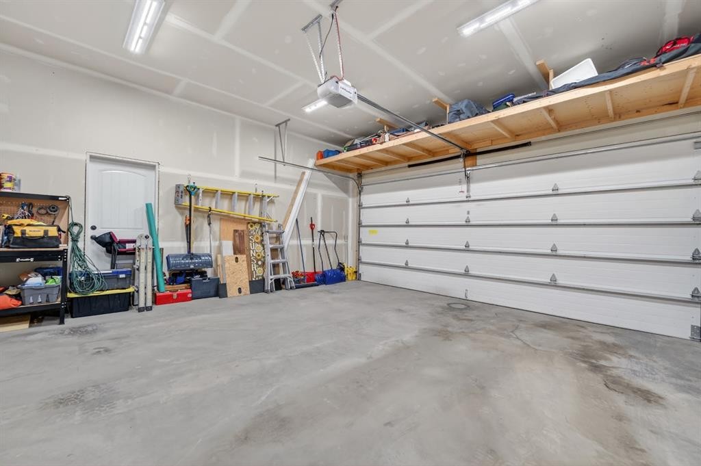 26 Mackenzie Way, Carstairs, AB - Indoor Photo Showing Garage