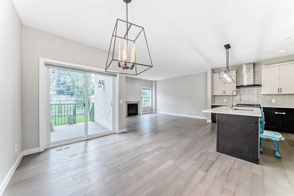 41 Shawnee Green Sw, Calgary, AB - Indoor Photo Showing Kitchen With Fireplace