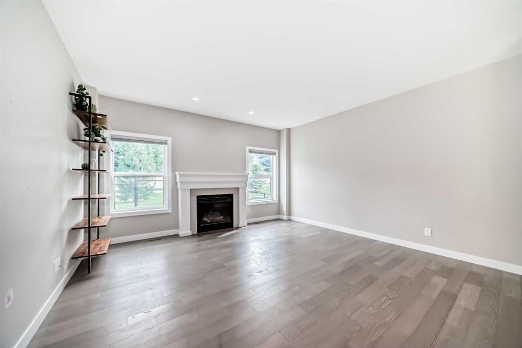 41 Shawnee Green Sw, Calgary, AB - Indoor Photo Showing Living Room With Fireplace