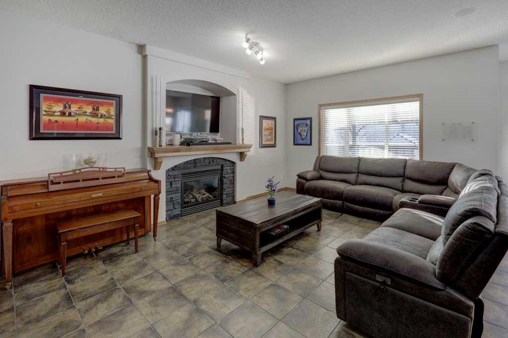 463 Cranfield Gardens Se, Calgary, AB - Indoor Photo Showing Living Room With Fireplace