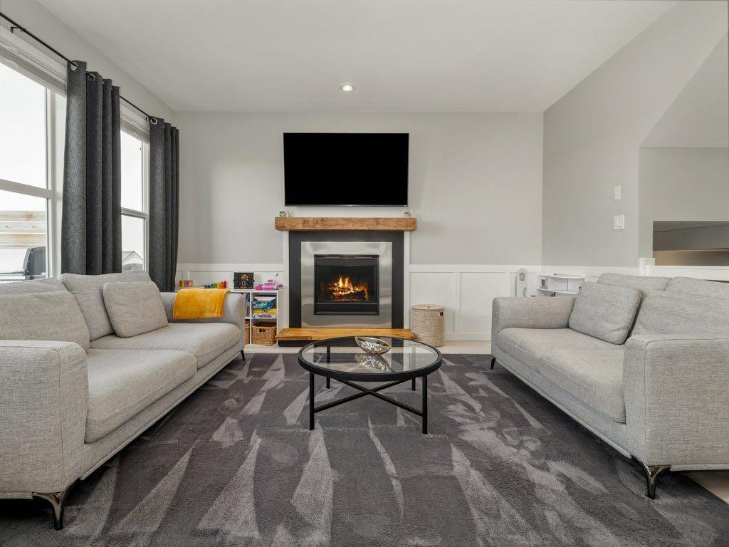 102 Blackwolf Bay North, Lethbridge, AB - Indoor Photo Showing Living Room With Fireplace