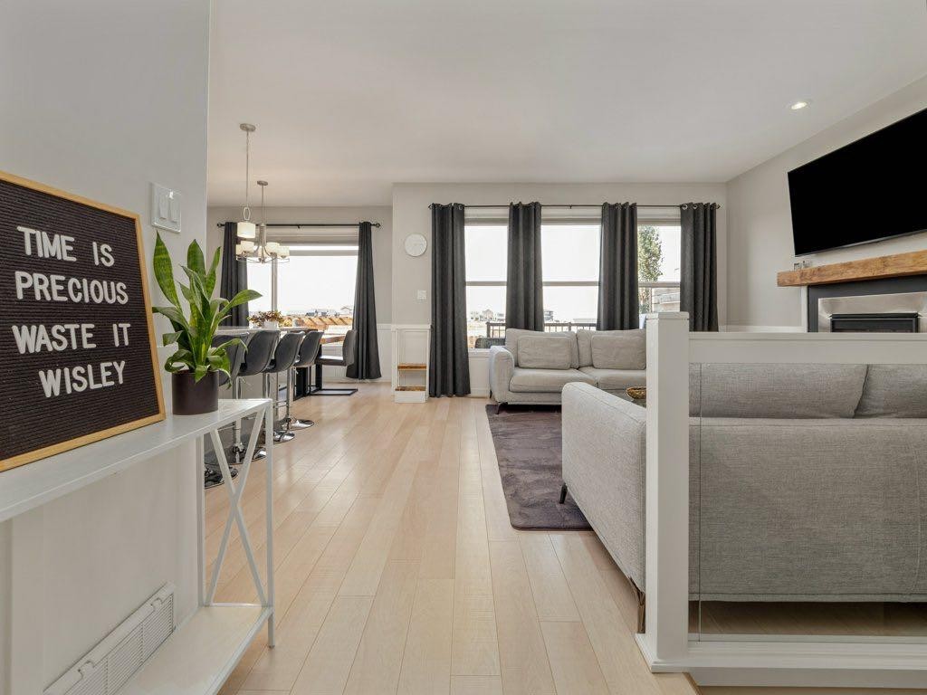 102 Blackwolf Bay North, Lethbridge, AB - Indoor Photo Showing Living Room With Fireplace