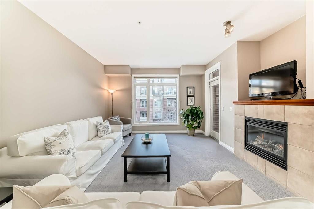4304-24 Hemlock Crescent Sw, Calgary, AB - Indoor Photo Showing Living Room With Fireplace