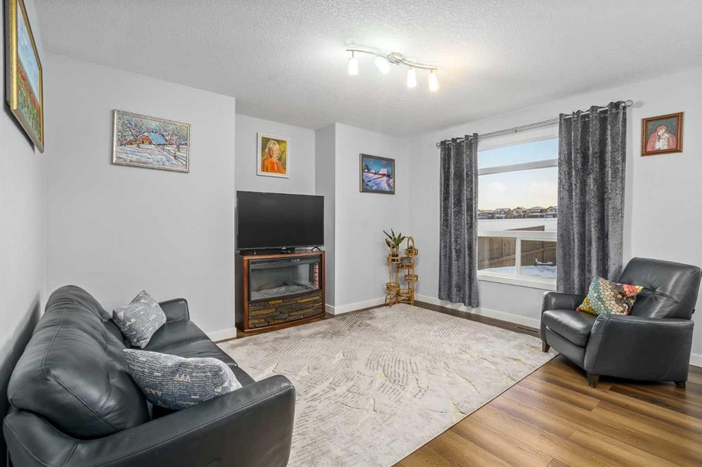 254 Silverado Plains Circle Sw, Calgary, AB - Indoor Photo Showing Living Room With Fireplace