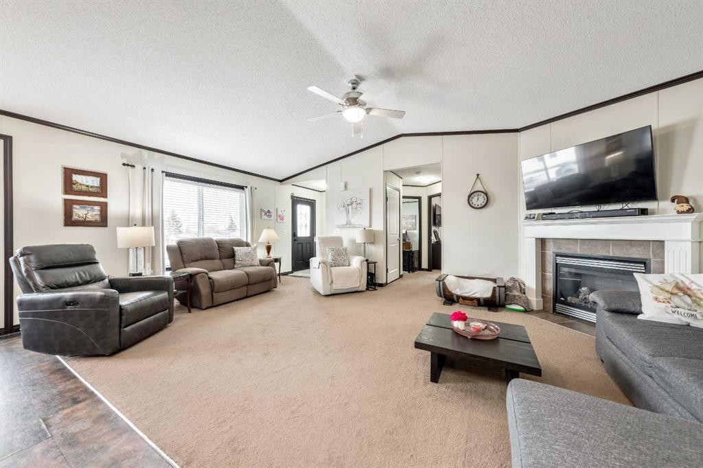 4 Spring Dale Circle Se, Airdrie, AB - Indoor Photo Showing Living Room With Fireplace