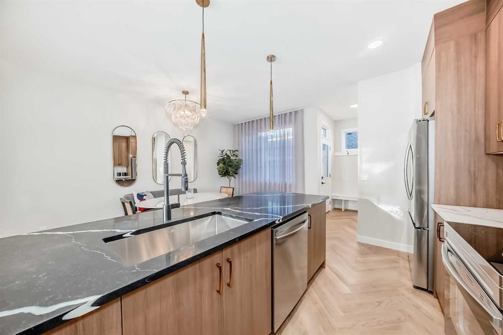 94 Agate Road, Cochrane, AB - Indoor Photo Showing Kitchen With Double Sink With Upgraded Kitchen