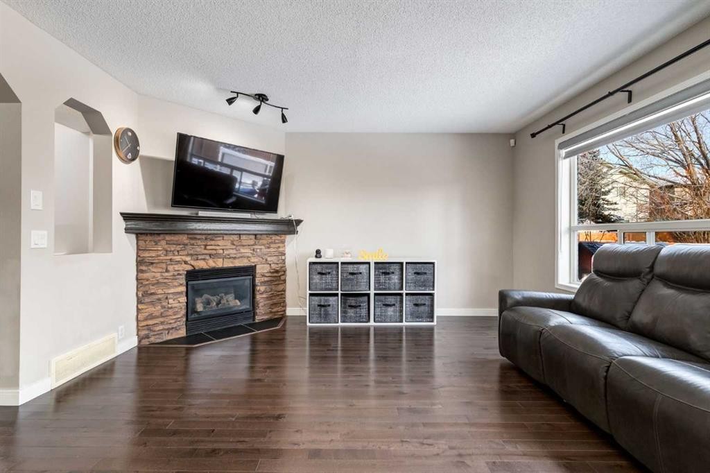 815 Tuscany Drive Nw, Calgary, AB - Indoor Photo Showing Living Room With Fireplace