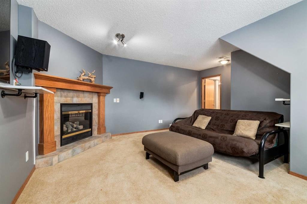140 Stonegate Close Nw, Airdrie, AB - Indoor Photo Showing Living Room With Fireplace