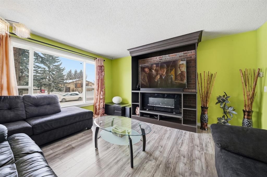 6411 26 Avenue Ne, Calgary, AB - Indoor Photo Showing Living Room With Fireplace
