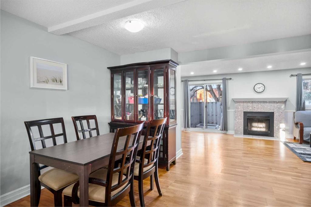 15-200 Shawnessy Drive Sw, Calgary, AB - Indoor Photo Showing Dining Room With Fireplace