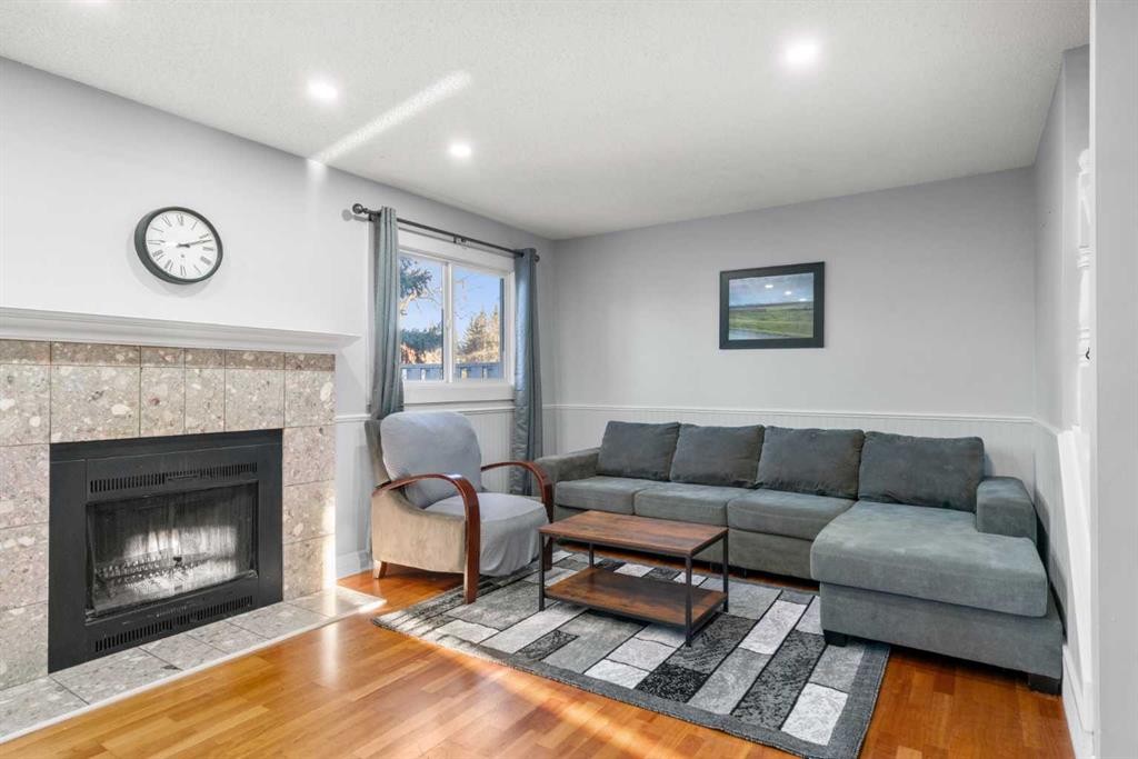 15-200 Shawnessy Drive Sw, Calgary, AB - Indoor Photo Showing Living Room With Fireplace