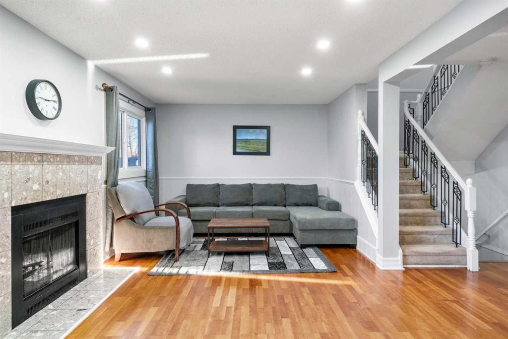 15-200 Shawnessy Drive Sw, Calgary, AB - Indoor Photo Showing Living Room With Fireplace