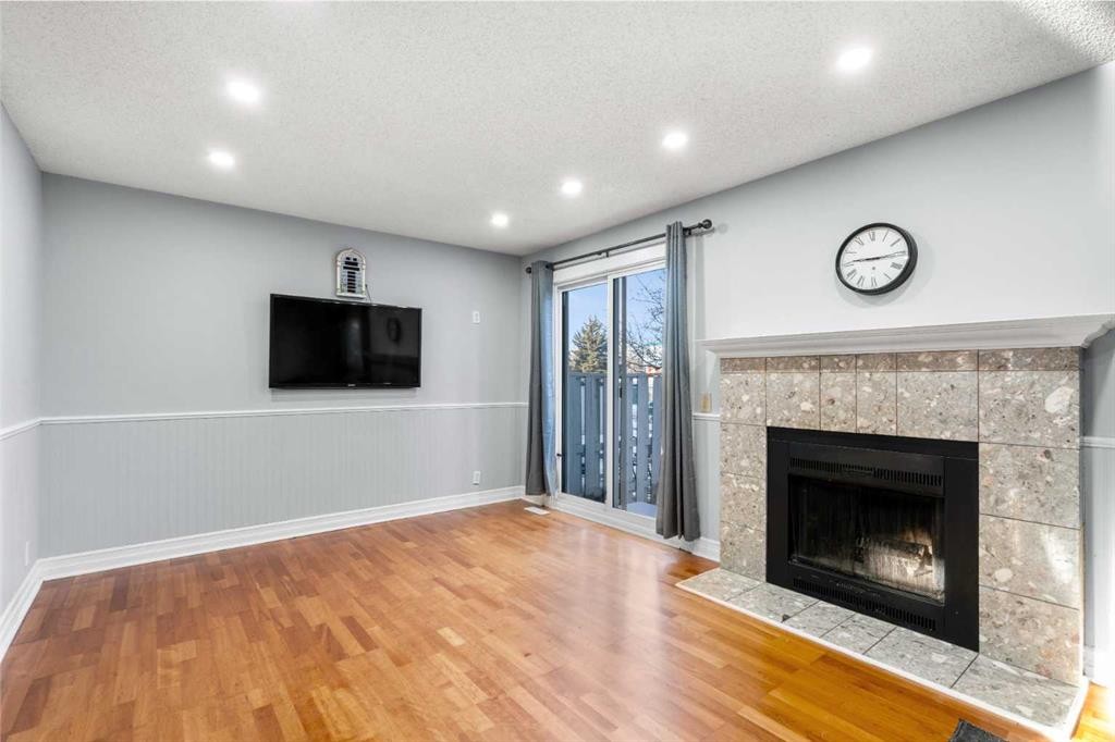 15-200 Shawnessy Drive Sw, Calgary, AB - Indoor Photo Showing Living Room With Fireplace