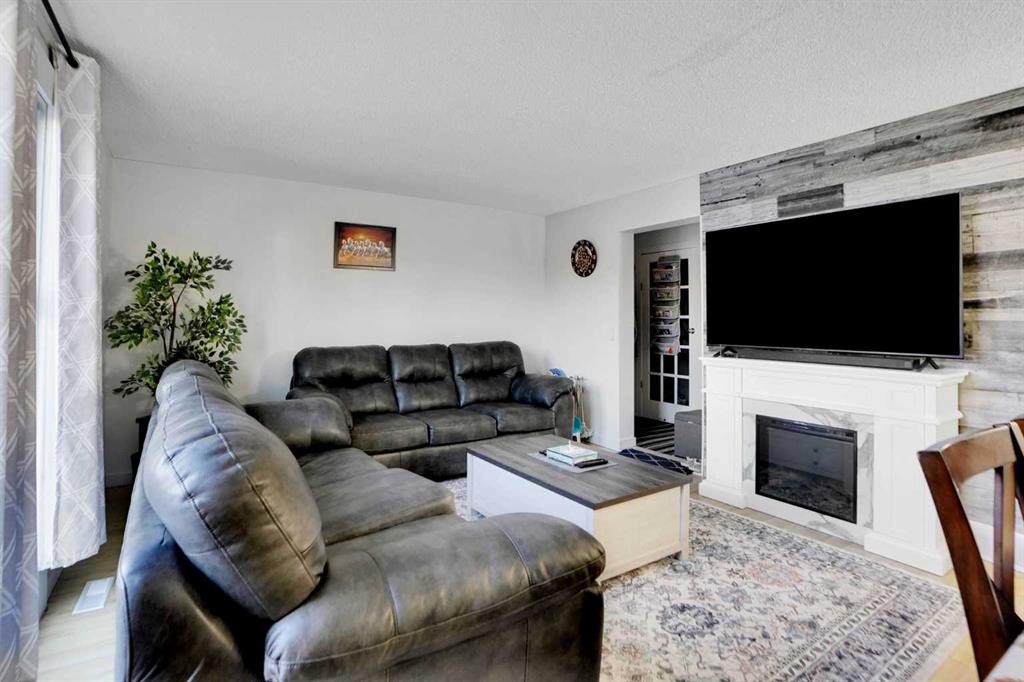 88 Abingdon Crescent Ne, Calgary, AB - Indoor Photo Showing Living Room With Fireplace