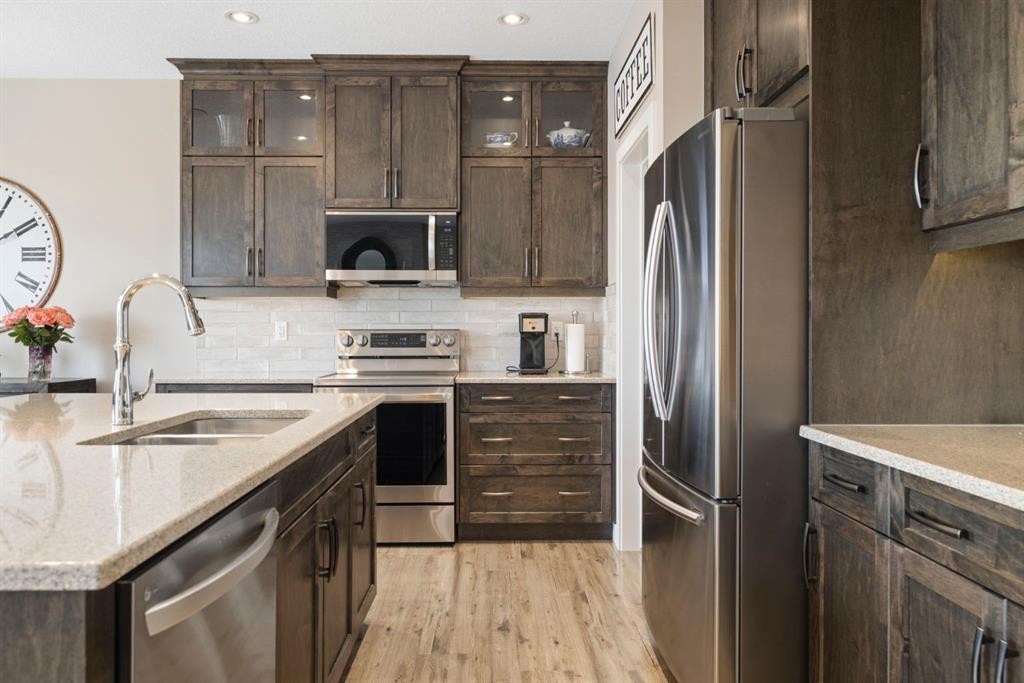 8 Emberside Glen, Cochrane, AB - Indoor Photo Showing Kitchen With Stainless Steel Kitchen With Double Sink With Upgraded Kitchen