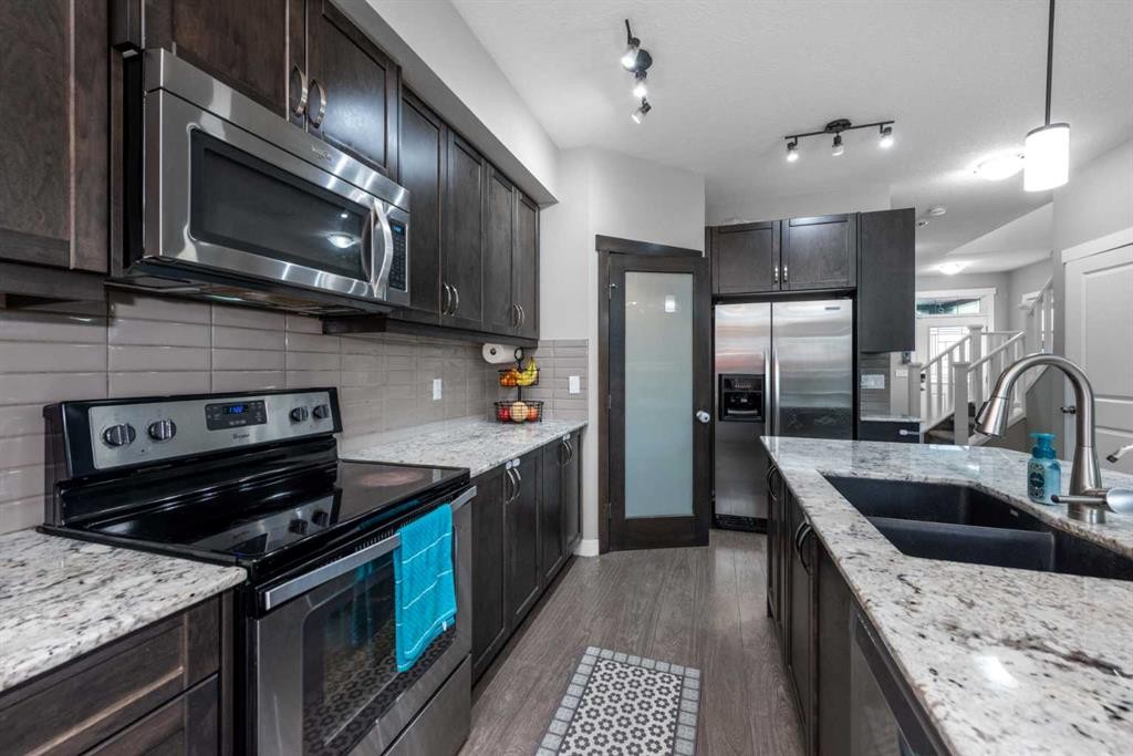 80 Legacy Reach Manor Se, Calgary, AB - Indoor Photo Showing Kitchen With Stainless Steel Kitchen With Double Sink With Upgraded Kitchen