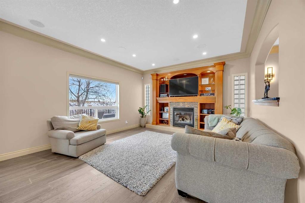 100 Cougarstone Manor Sw, Calgary, AB - Indoor Photo Showing Living Room With Fireplace