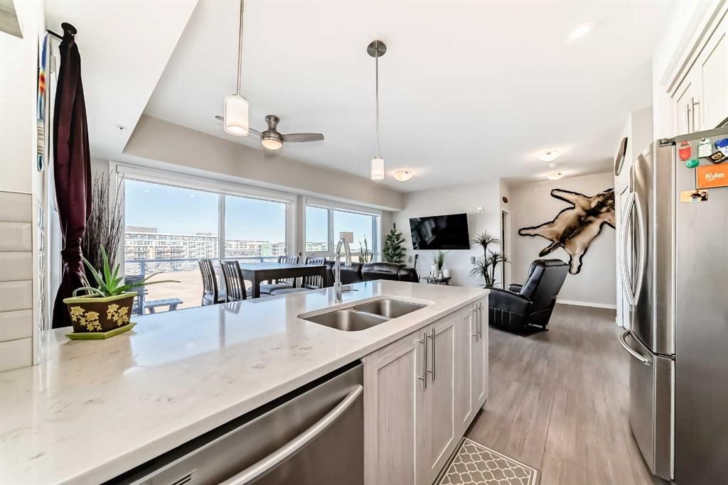 409-4150 Seton Drive Se, Calgary, AB - Indoor Photo Showing Kitchen With Double Sink With Upgraded Kitchen