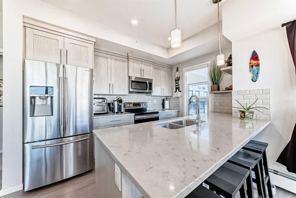 409-4150 Seton Drive Se, Calgary, AB - Indoor Photo Showing Kitchen With Double Sink With Upgraded Kitchen