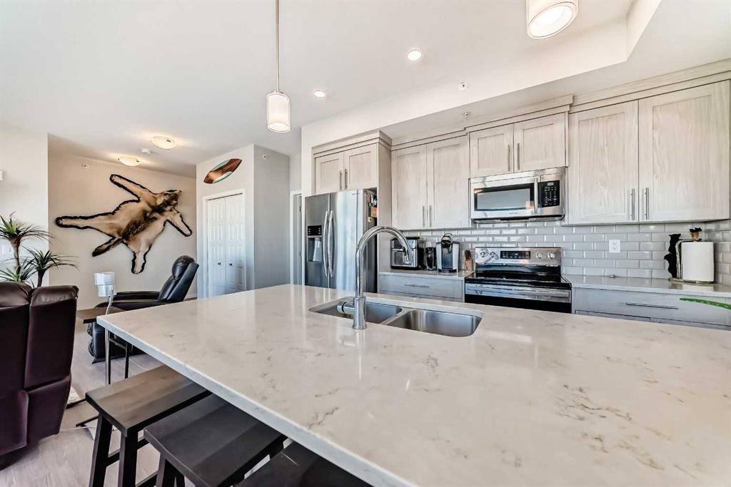 409-4150 Seton Drive Se, Calgary, AB - Indoor Photo Showing Kitchen With Double Sink With Upgraded Kitchen