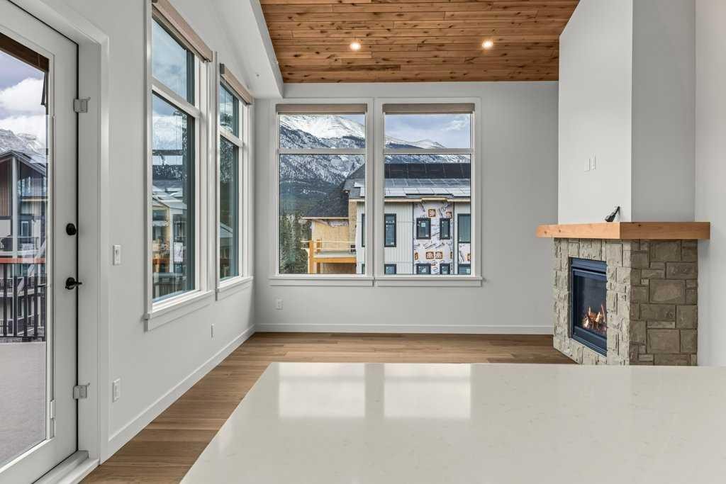 407-1505 Spring Creek Gate, Canmore, AB - Indoor With Fireplace