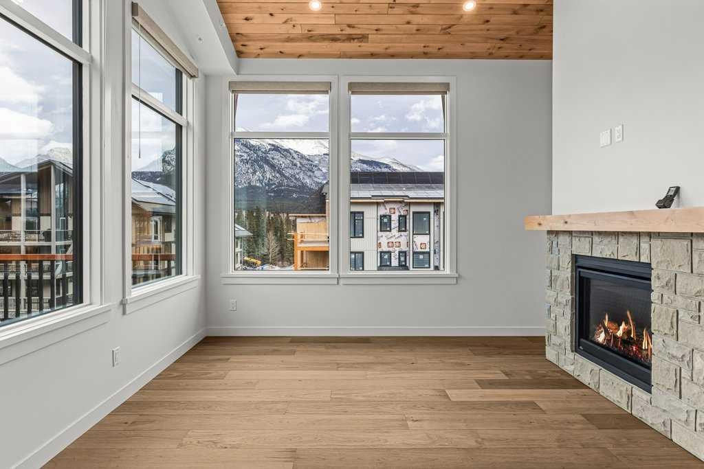 407-1505 Spring Creek Gate, Canmore, AB - Indoor With Fireplace