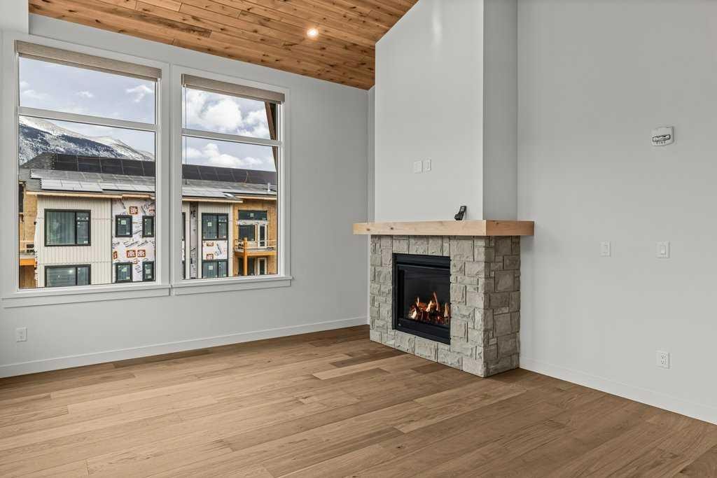 407-1505 Spring Creek Gate, Canmore, AB - Indoor Photo Showing Living Room With Fireplace