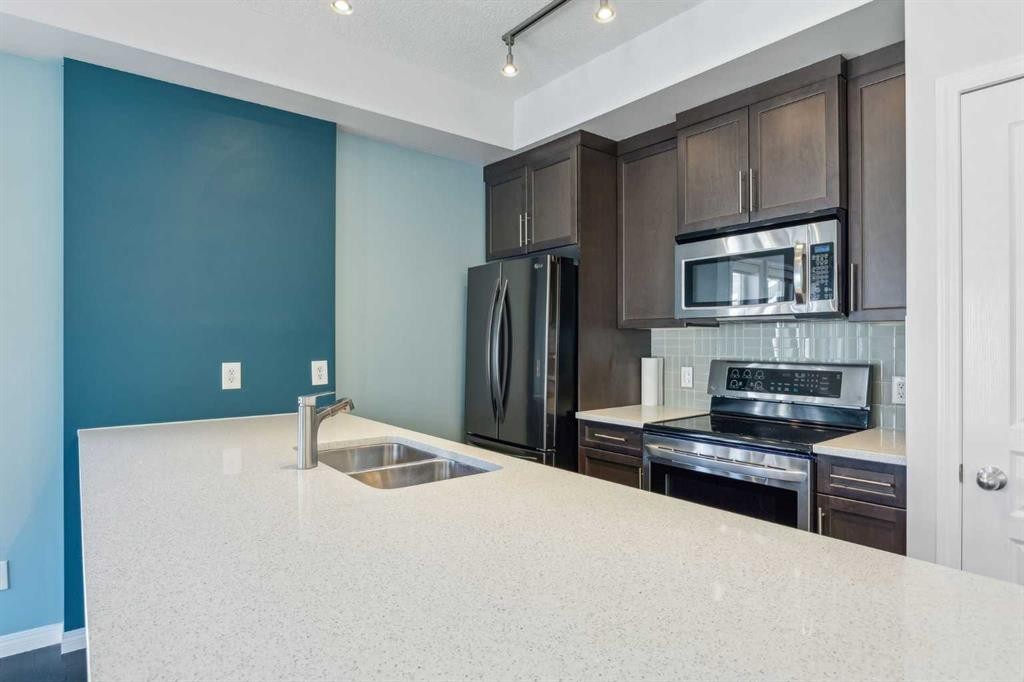 1006 Auburn Bay Square Se, Calgary, AB - Indoor Photo Showing Kitchen With Stainless Steel Kitchen With Double Sink