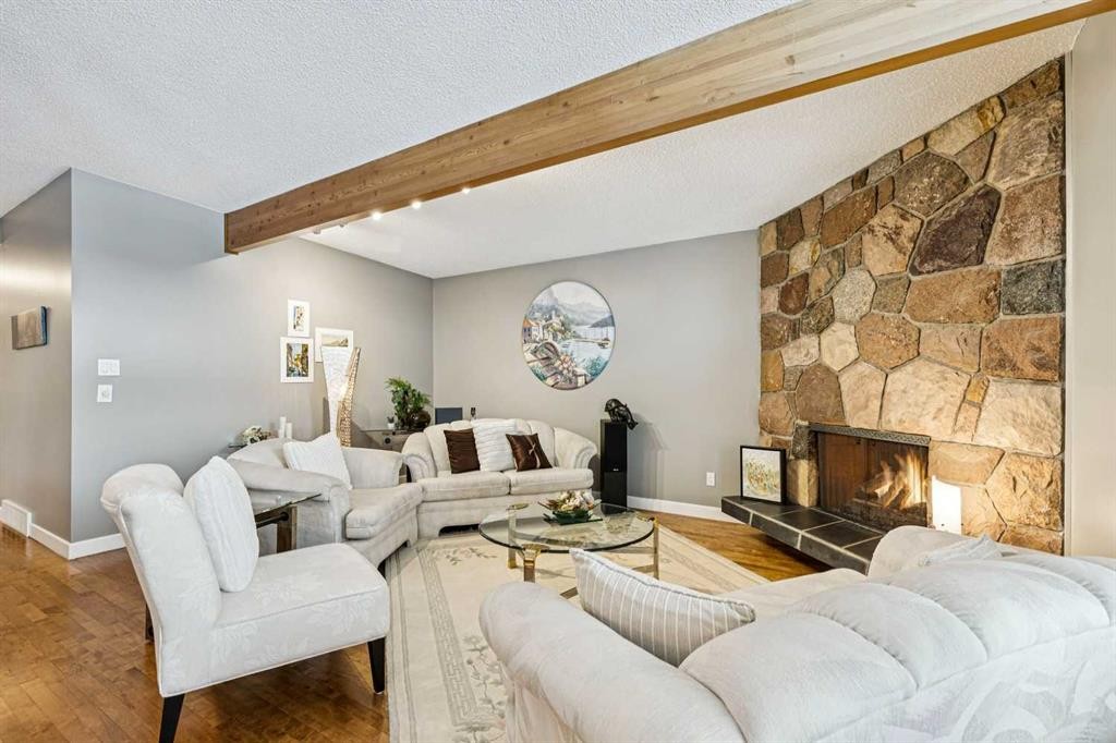 8 Vardana Place Nw, Calgary, AB - Indoor Photo Showing Living Room With Fireplace