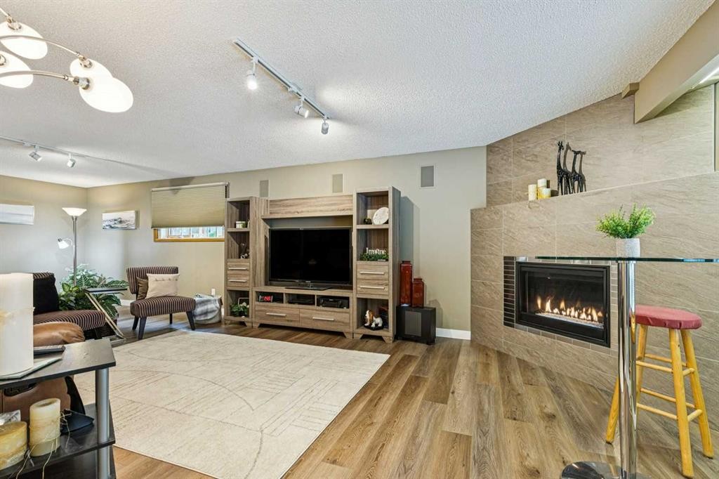8 Vardana Place Nw, Calgary, AB - Indoor Photo Showing Living Room With Fireplace