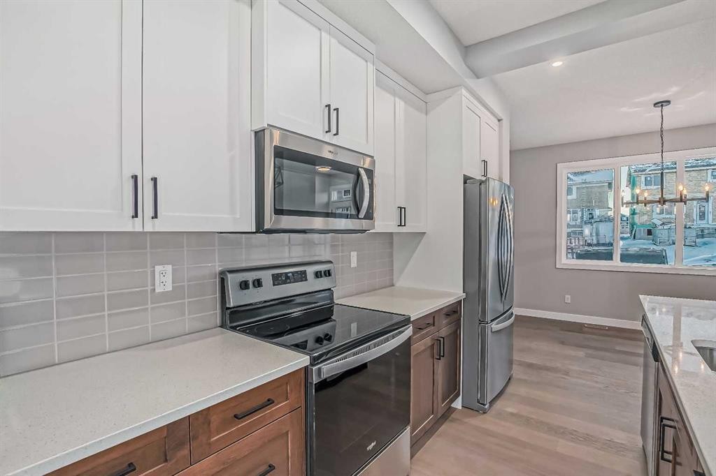 39 Agate Road, Cochrane, AB - Indoor Photo Showing Kitchen With Upgraded Kitchen