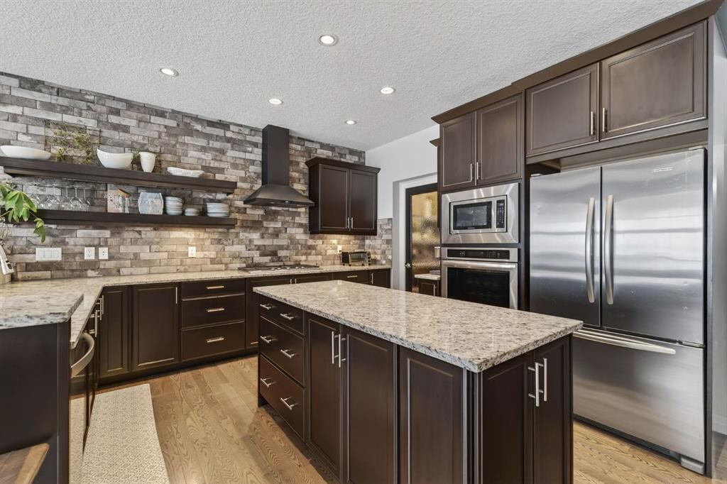 105 Riviera Crescent, Cochrane, AB - Indoor Photo Showing Kitchen With Stainless Steel Kitchen With Upgraded Kitchen
