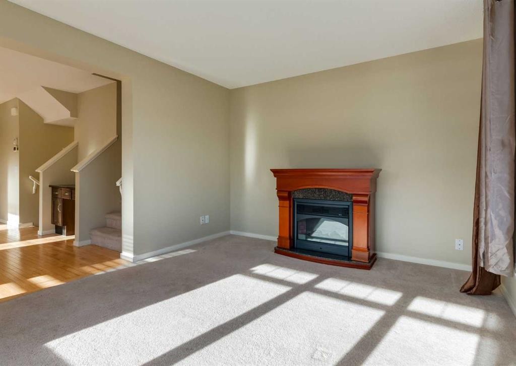 236 Silverado Drive Sw, Calgary, AB - Indoor Photo Showing Living Room With Fireplace