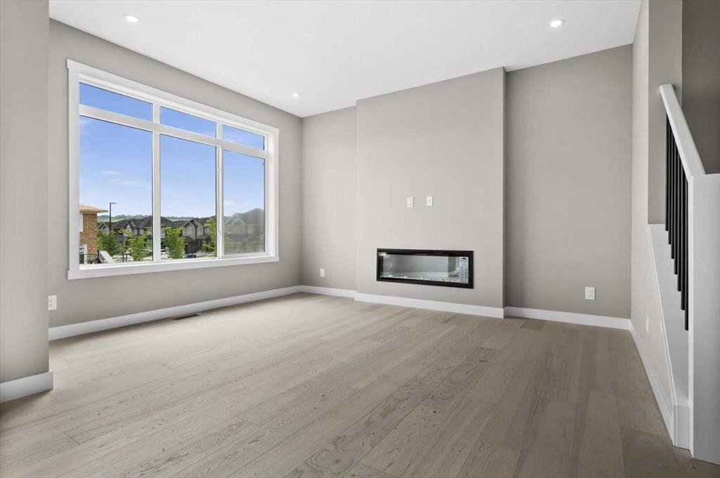 8 Topaz Place, Cochrane, AB - Indoor Photo Showing Other Room With Fireplace
