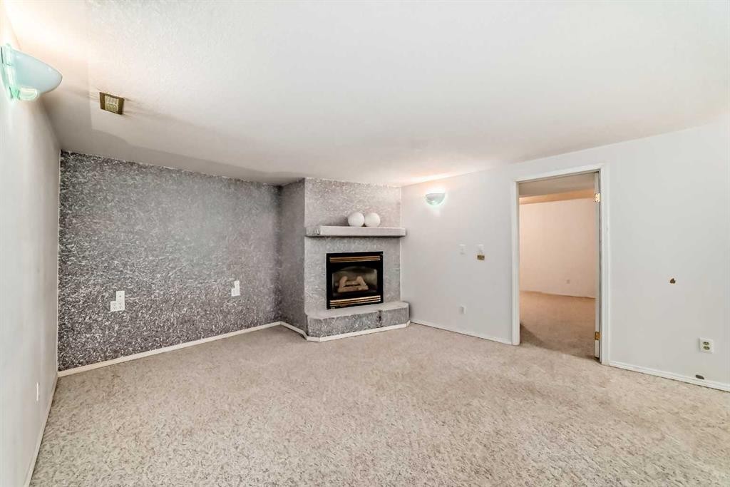 352 Malvern Close Ne, Calgary, AB - Indoor Photo Showing Living Room With Fireplace